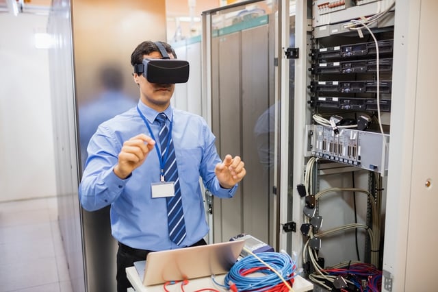 Technician using visual reality headset in server room.jpeg